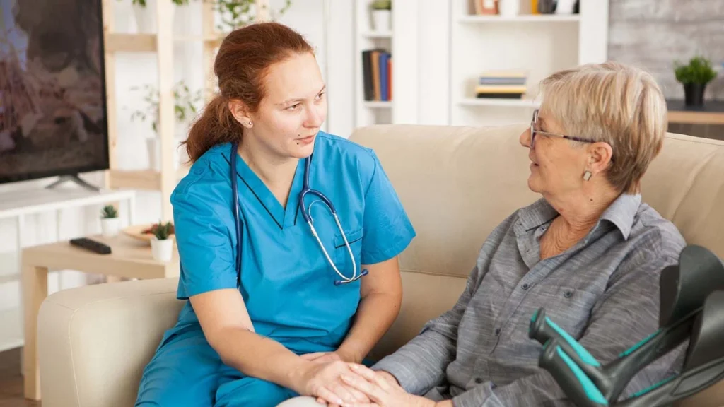 female nurse having conversation with pensioner woman nursing home 482257 22845